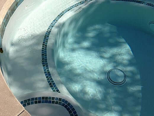 Clear water in a pool featuring decorative tiles, ideal for aquatic design projects.