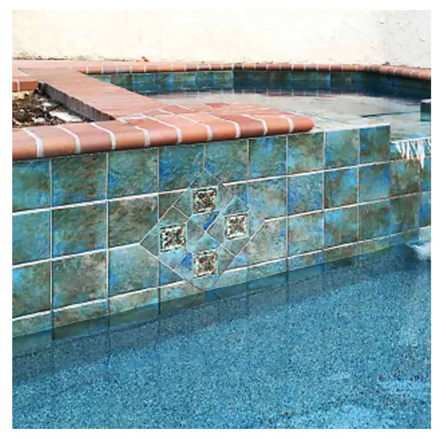 Fujiwa Joya Albi 6" Deco Series Semi Glossy Pool Rated Porcelain Tile in stylish pool area with decorative blue accents.