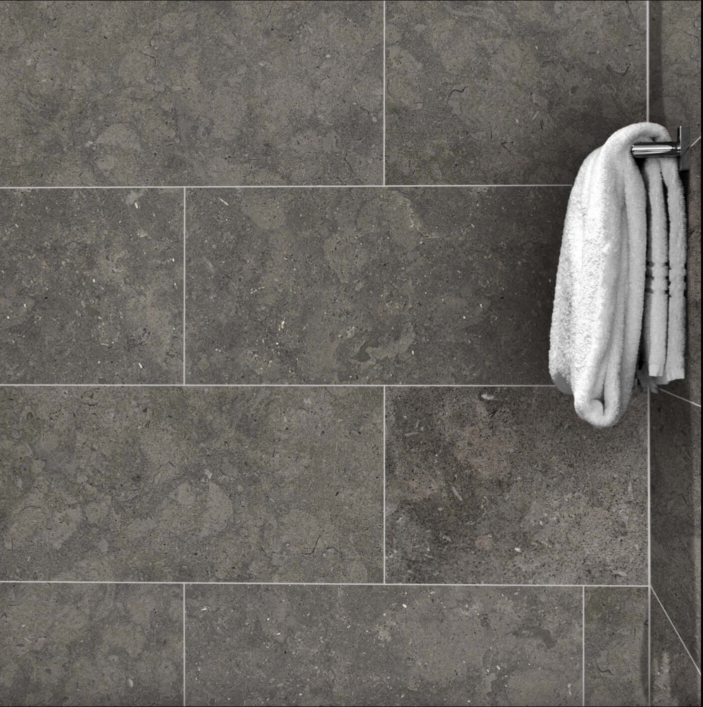 12x24 Lagos Azul Honed Limestone tile with a clean, modern design featuring a towel hanging on the wall.