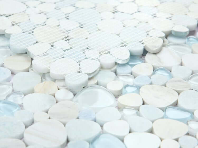 Close-up of Peach Marina mosaic tile featuring a blend of smooth, rounded stones in soft blues and whites, ideal for interior design.