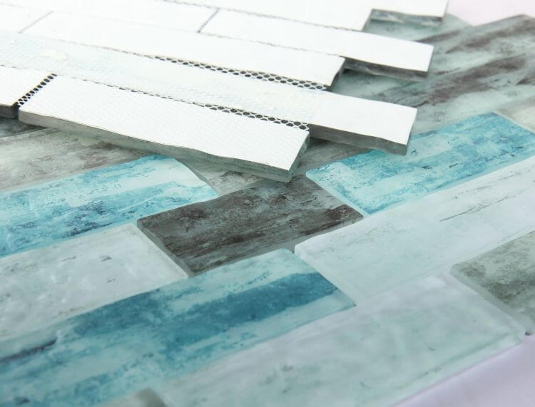 Art Ocean Casale 11.75x11.75 glass mosaic featuring tranquil blue-grey hues and a stylish linear brick pattern.