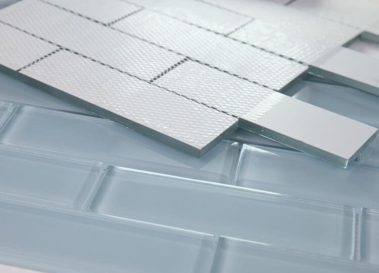 Casale Lucy Blue glass tiles, hand-painted in light blue, showcasing subway layout for stylish swimming pool installations.