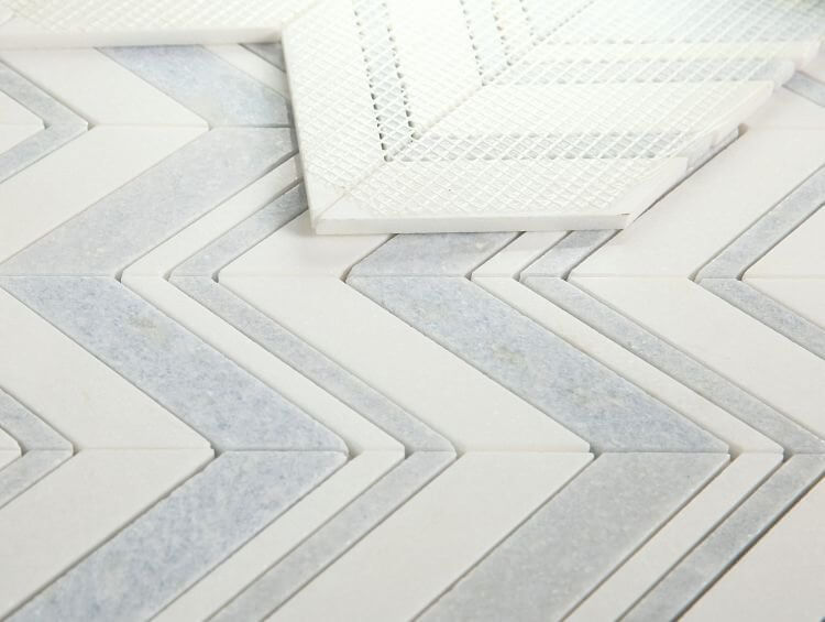 Thassos Azul Chevron marble mosaic in a stylish chevron pattern, featuring White Thassos and Azul Cielo marbles.