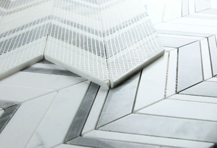 Chevron Ravenna Grey marble mosaic tiles showcasing a sophisticated chevron design in grey and white.