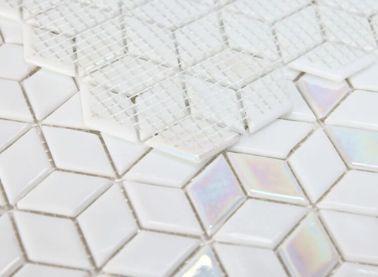 Close-up of Cube White 11.5x11.75 diamond-shaped recycled glass mosaic, showcasing iridescent pieces in a cubic design.