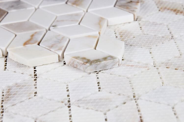 Cubic Calacatta Gold mosaic tiles in polished finish, featuring white and gold marble in a diamond pattern.