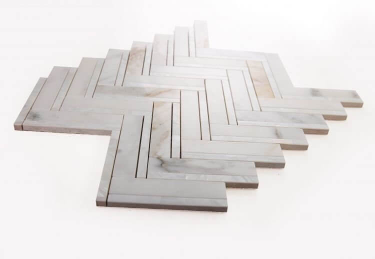 Diana Herringbone Calacatta mosaic tile featuring white and gold marble, ideal for stylish interior designs.