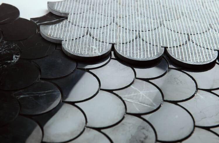Close-up of Dragon Scale Marquina mosaic tiles, showcasing polished black Nero Marquina marble design.