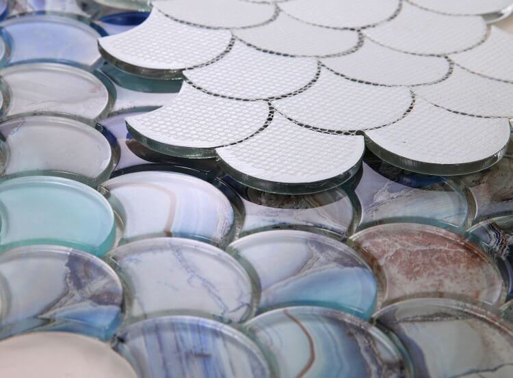 Close-up of Dragon Scale Shell Blue glass mosaics featuring an oceanic design with glossy finish.