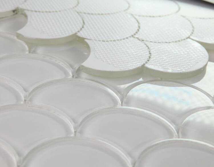 Close-up of Dragon Scale White Glass mosaic tile, showcasing its unique dragon scale pattern in glossy finish.