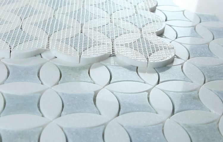 Embrace Crystal Ocean marble mosaic tile in blue and white, 11.75 x 11.75 inches, featuring circular patterns, ideal for elegant designs.