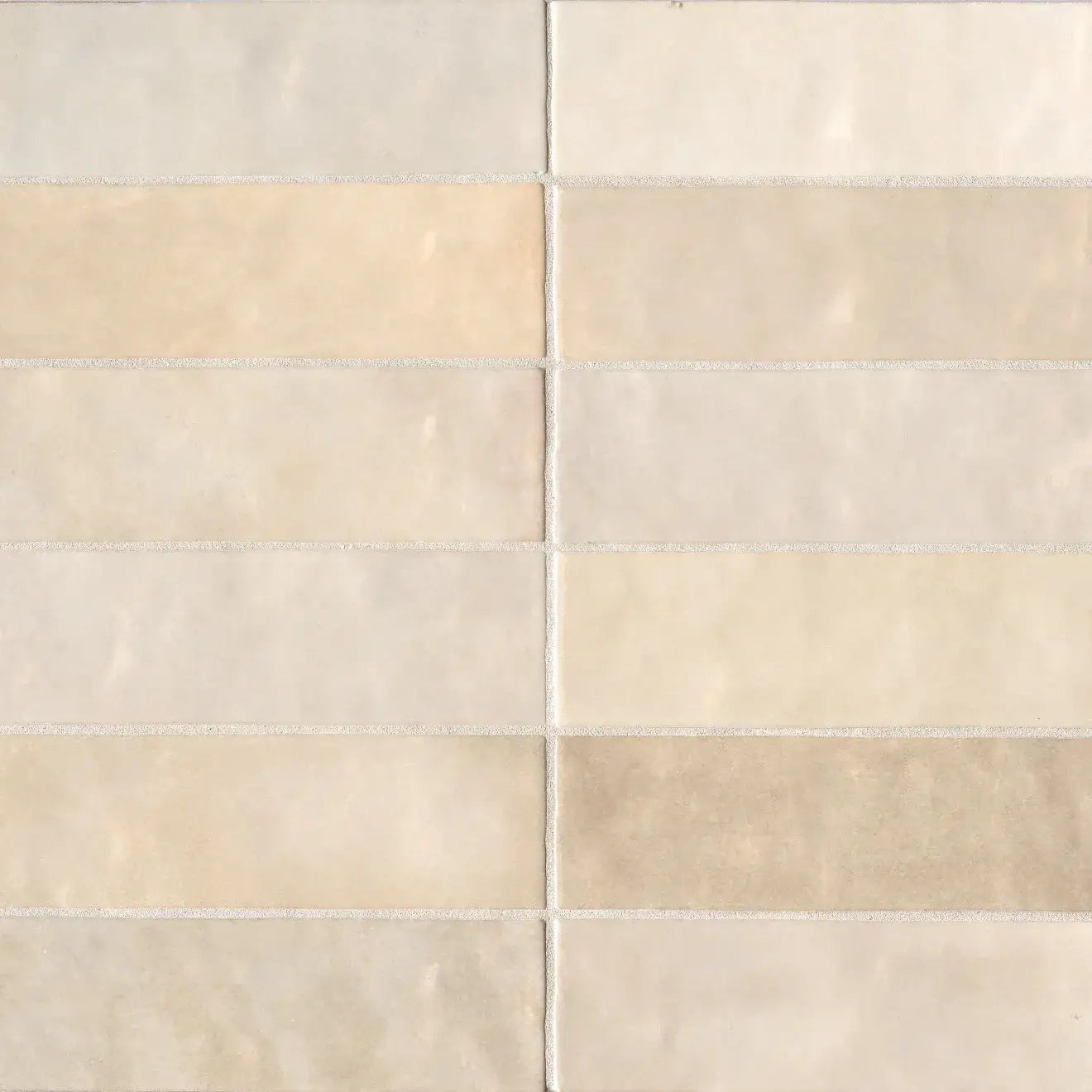 Cloé 2.5" x 8" glossy ceramic tile in soft creme shades, ideal for warm and elegant interior designs.