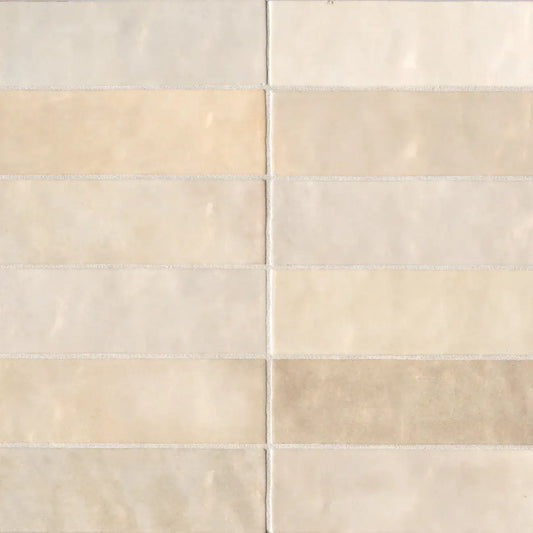 Cloé 2.5" x 8" glossy ceramic tile in soft creme shades, ideal for warm and elegant interior designs.