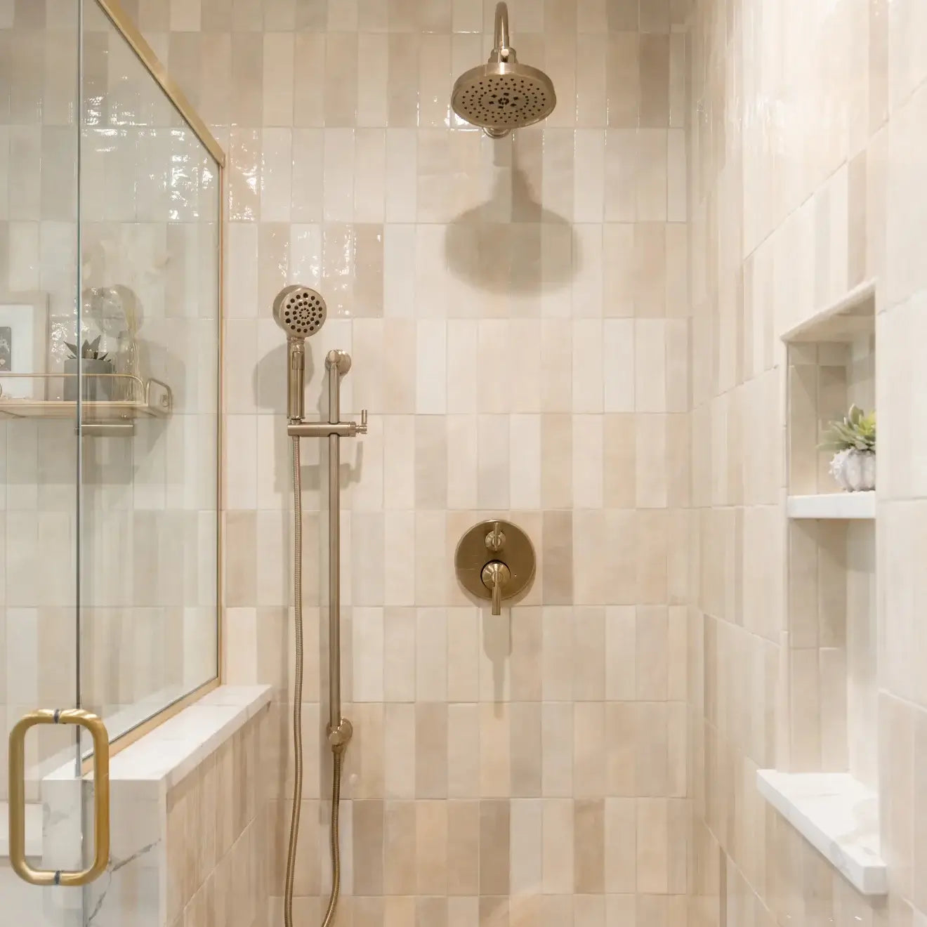 Elegant shower with Cloé 2.5" x 8" glossy creme ceramic tile and stylish fixtures, creating a warm atmosphere.