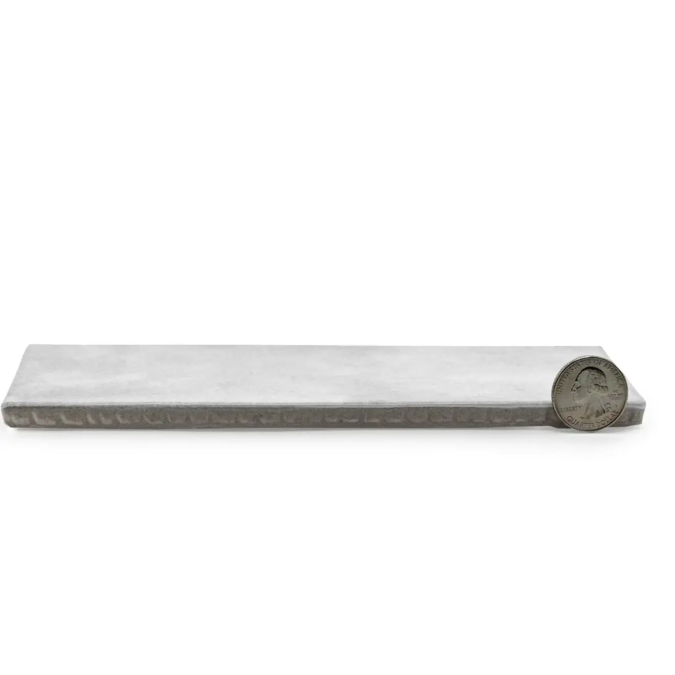 Cloé 2.5" x 8" glossy grey ceramic tile demonstrating sleek design and modern elegance next to a quarter for size reference.