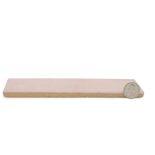 Cloé 2.5x8 glossy pink ceramic tile with quarter for size comparison.
