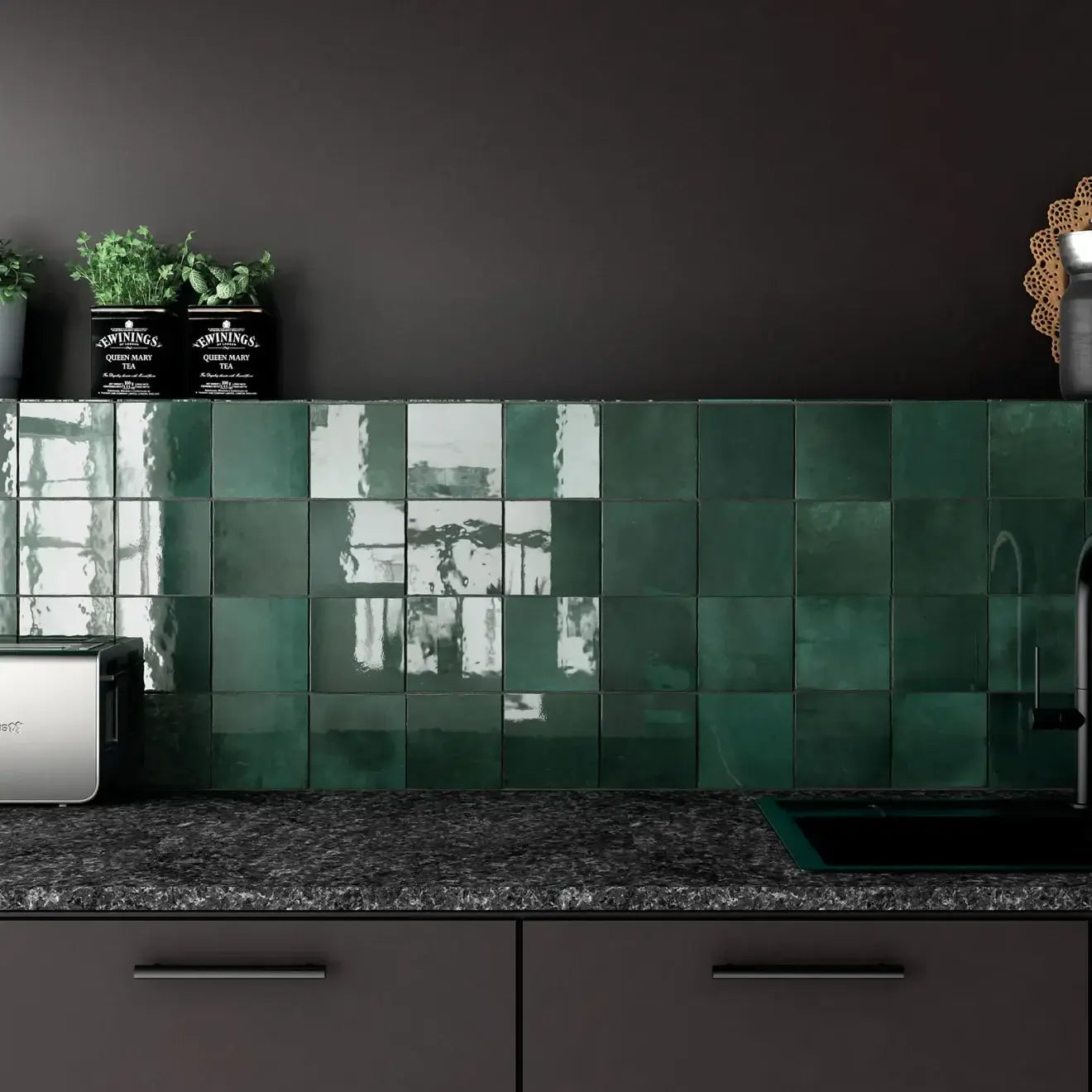 Glossy green ceramic tiles on kitchen backsplash, enhancing space with vibrant color and reflective finish.
