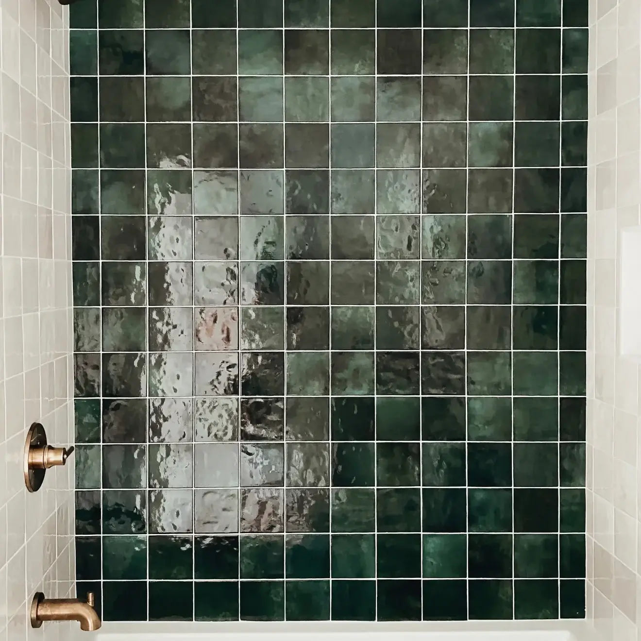 Glossy green ceramic tile installation in shower, featuring vibrant tiles in 5" x 5" square format.