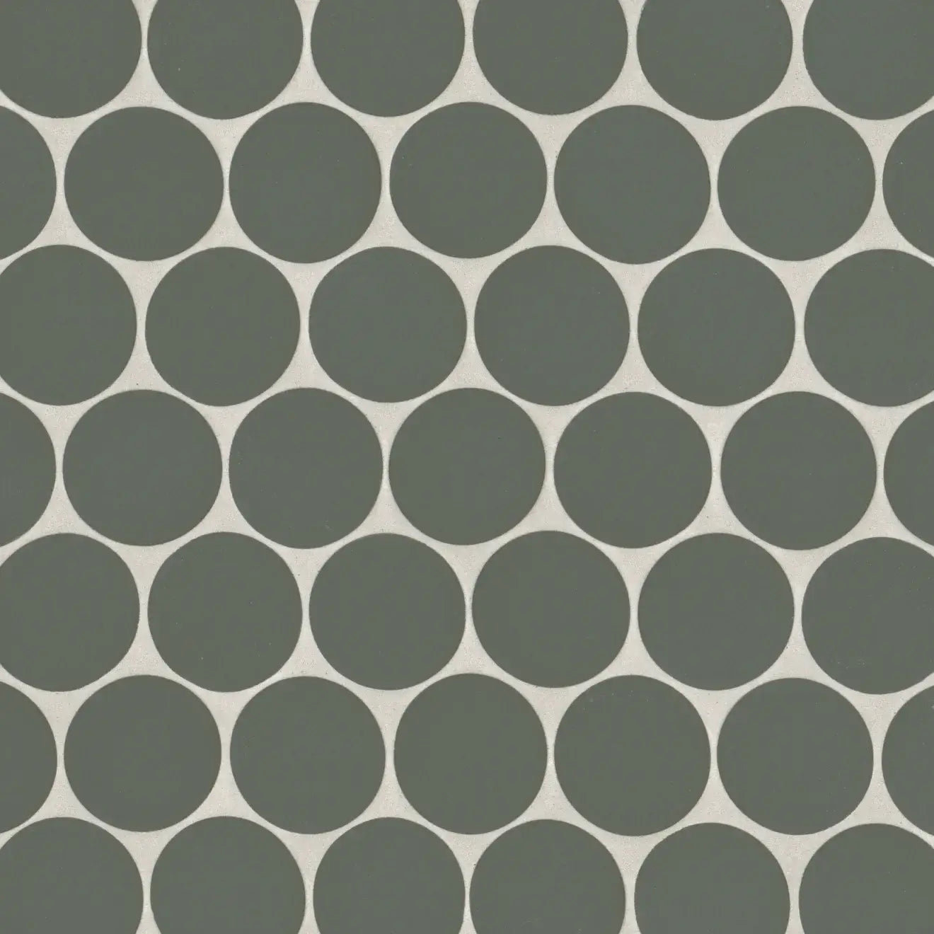 Makoto 2" round matte porcelain mosaic tile in Midori Green, featuring a pattern of soothing circular shapes.