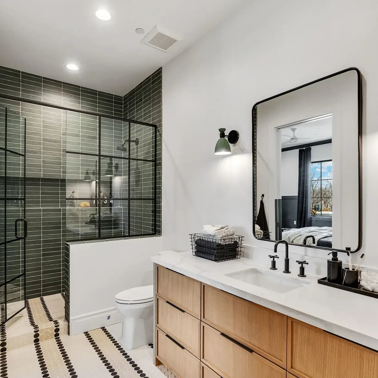 Modern bathroom design featuring a sleek glass shower, wooden vanity, and stylish fixtures.