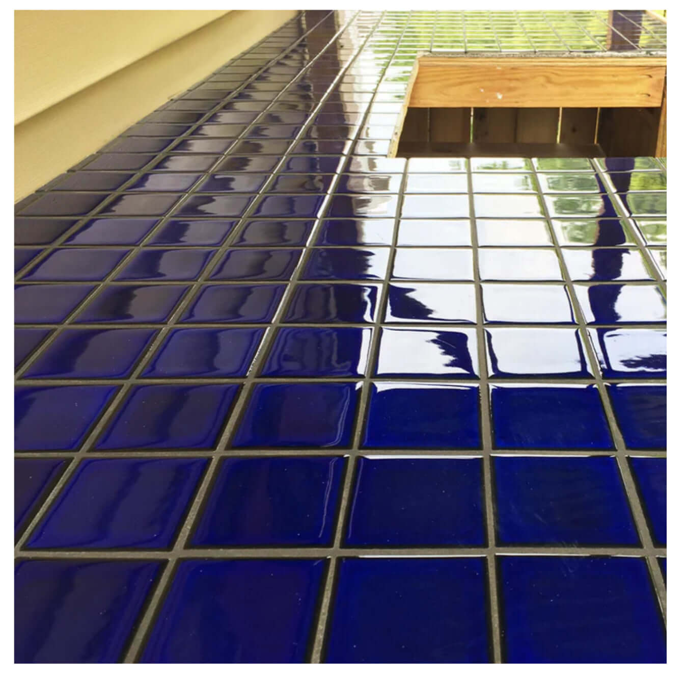 Cobalt blue 3x3 pool-rated mosaic tiles on a surface, ideal for striking aquatic designs.