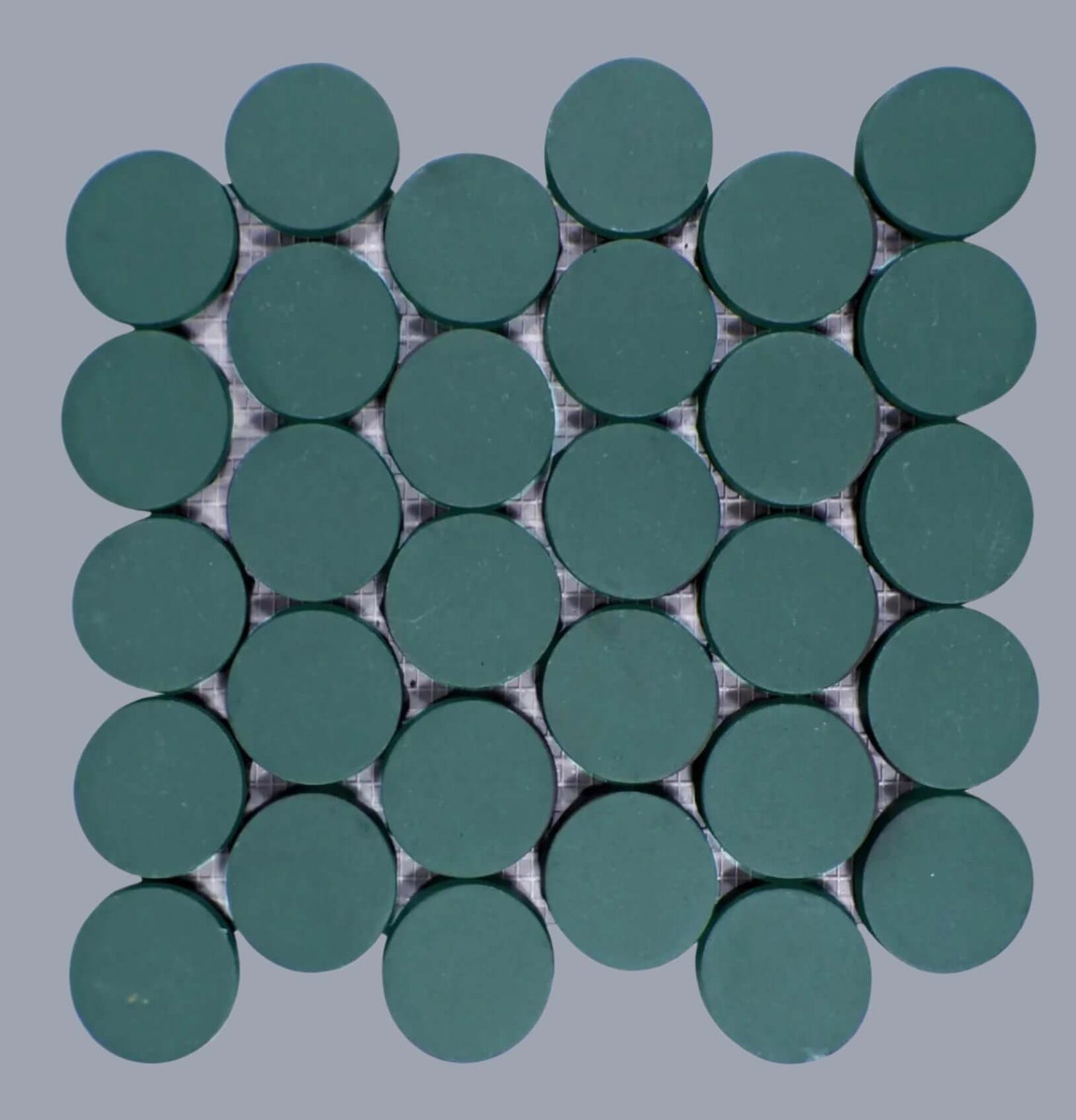 Makoto 2-inch round matte porcelain mosaic tiles in Midori Green, arranged in a grid pattern.
