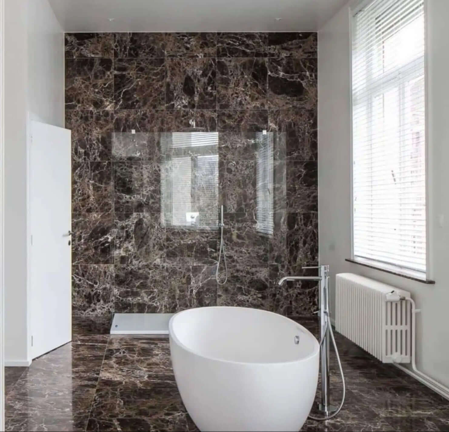 Luxurious bathroom featuring 12x12 Iberian Emperador Dark Marble tiles and a modern freestanding bathtub.