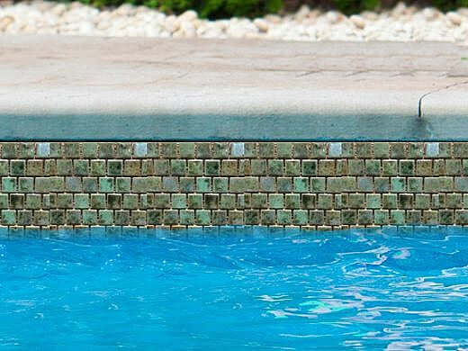 Fujiwa Tile Joya Series 1x1 Verde tiles installed in pool area, offering vibrant color and pool-rated quality.