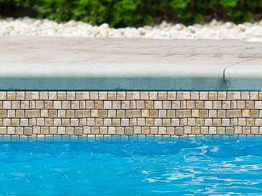Fujiwa Tile Joya Series 1x1 Gold Pool Rated Tiles showcased along a blue swimming pool.