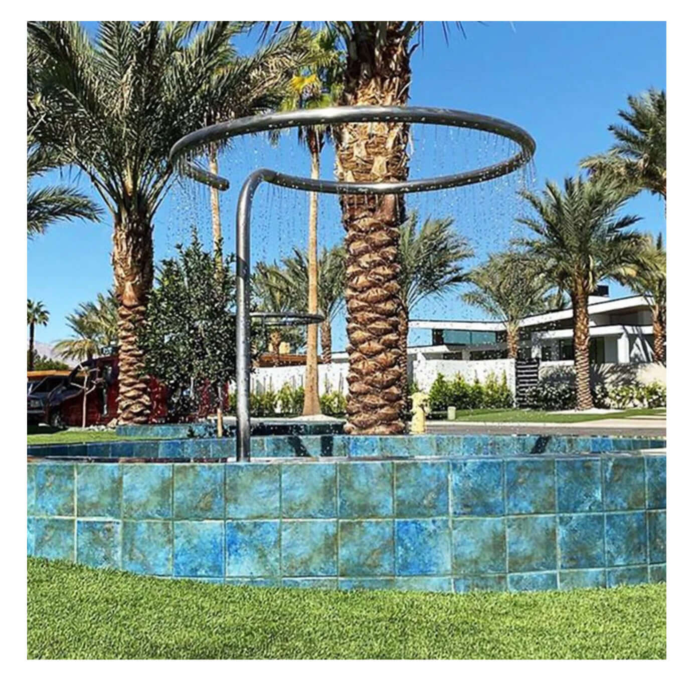 Fujiwa Joya Albi 6x6 semi gloss porcelain tiles in a luxurious pool area with palm trees.