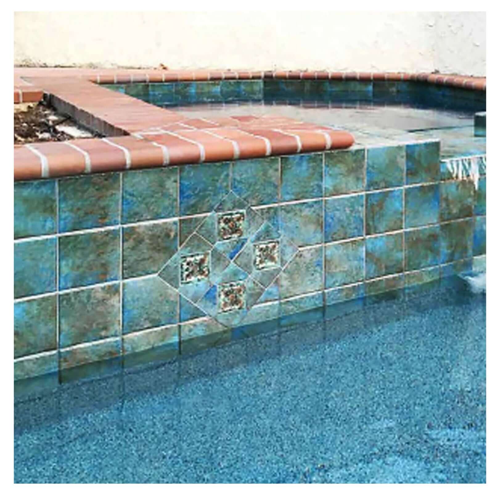 Fujiwa Joya Albi 6" Deco Series Semi Glossy Pool Rated Porcelain Tile in stylish pool area with decorative blue accents.