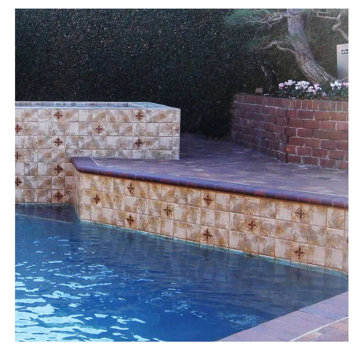 Fujiwa Joya Gold 6" Deco Series Semi Glossy Porcelain Tile accentuating a beautifully designed pool area.