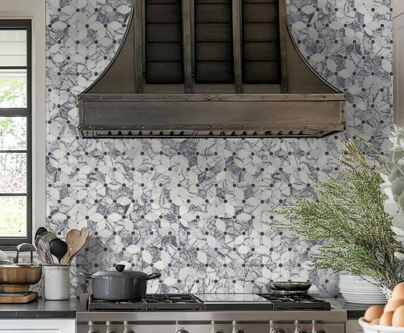 Calacatta Violet Lilac Cecily Pattern Mosaic Tile backsplash in a modern kitchen featuring a stylish hood.