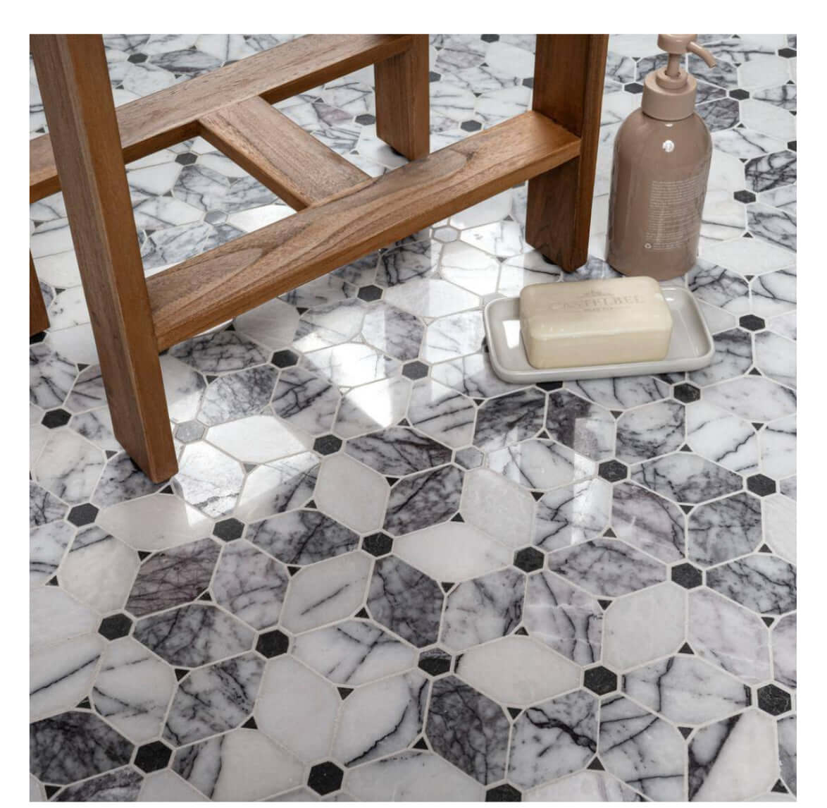 Calacatta Violet Lilac Cecily Pattern Mosaic Tile on a floor with wooden stool and bathroom essentials.