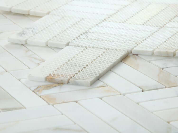 Close-up of Diamond Calacatta Gold honed tile featuring a unique diamond pattern, perfect for elegant interior designs.