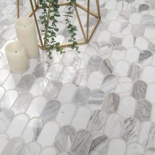 Edessa Scallop White polished marble mosaic flooring with candles and greenery, showcasing elegant interior design.