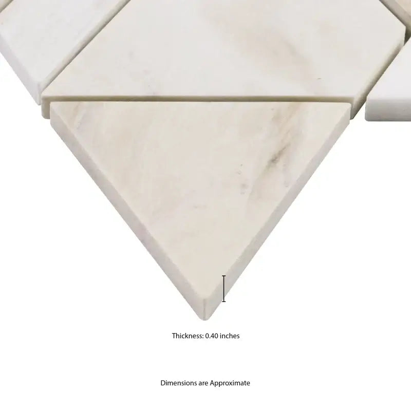 Close-up of Angora Floralis polished marble mosaic tile showing thickness of 0.40 inches and triangle shape.
