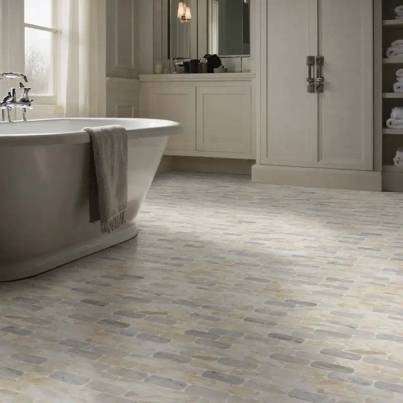 Luxurious bathroom featuring polished marble mosaic floor tiles and freestanding bathtub.