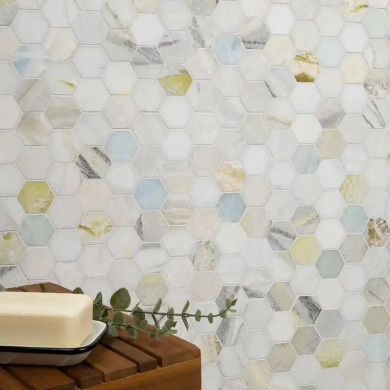 Cloudland 2" hexagon polished marble mosaic tile wall design in soft hues of white, blue, gray, and yellow, showcasing elegant patterns.