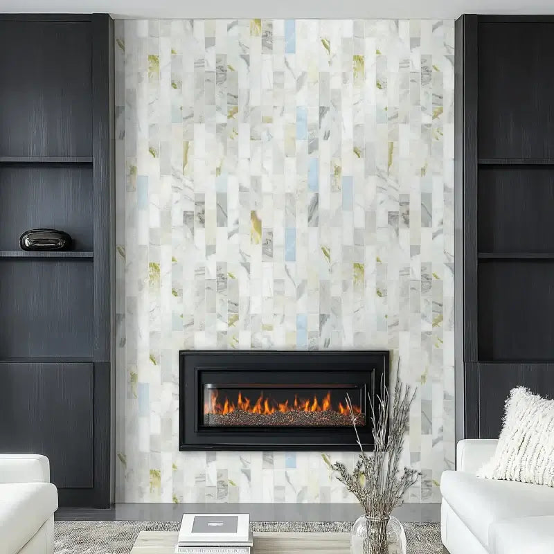Elegant living room featuring Cloudland 2x6 polished marble subway mosaic tile accent wall with black fireplace.