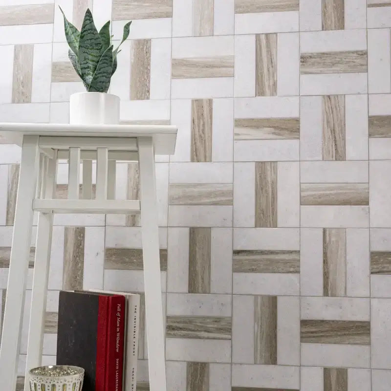 Winslow Weave 12" x 12" polished marble mosaic wall design with modern white stool and decorative plant.