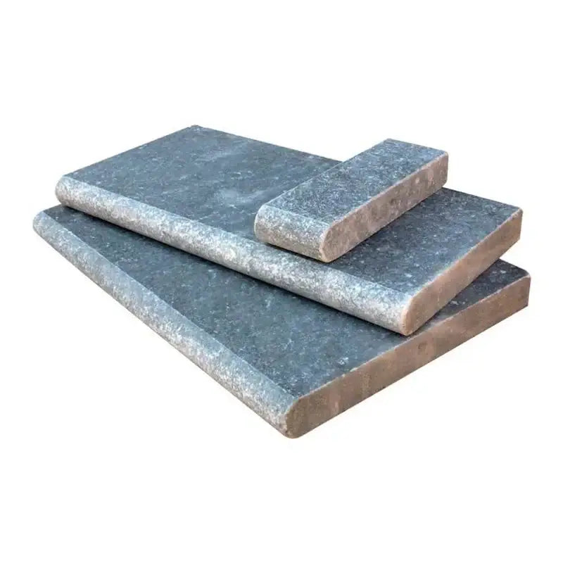 Atlantic Blue tumbled marble pool coping pieces showcasing rustic texture and blue tones for elegant poolside design.