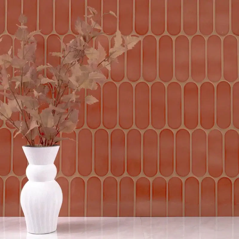 Terra Ellipse 12" X 12" glossy glass mosaic wall tile in earthy tones with modern ellipse design and decorative vase.