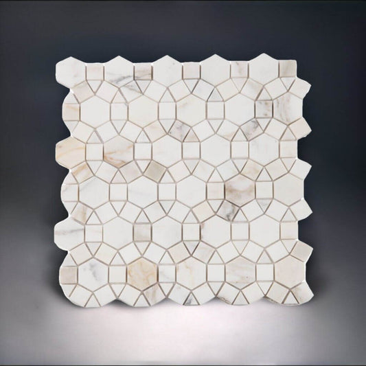 Aether Calacatta honed mosaic featuring intricate hexagonal, square, and triangular patterns in elegant marble.