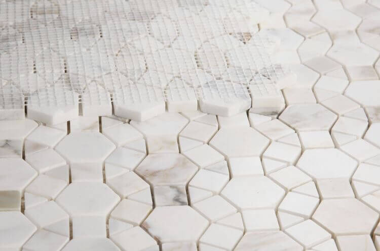 Aether Calacatta 11.5x12 mosaic showcasing intricate hexagonal and square tile patterns in natural marble.