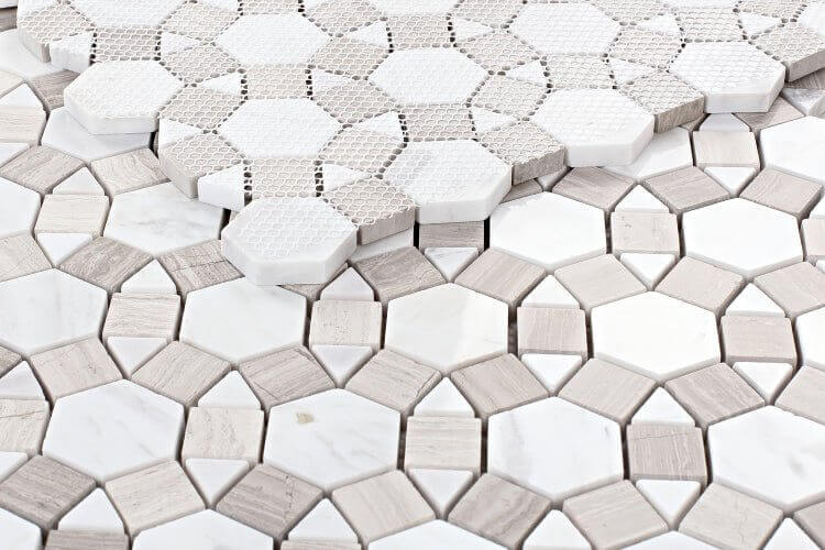 Close-up of Aether Loft mosaic with hexagon and polygon tiles in white and gray marble patterns.