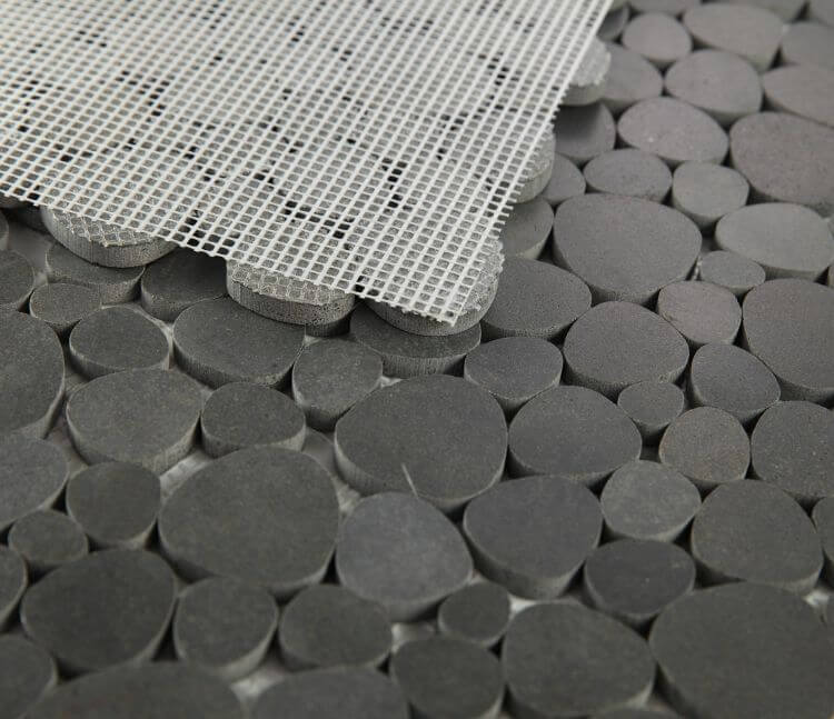 Aphrodite Basalt 12 x 12 tile with pebble design, showcasing grey and black hues for a stunning mosaic effect.