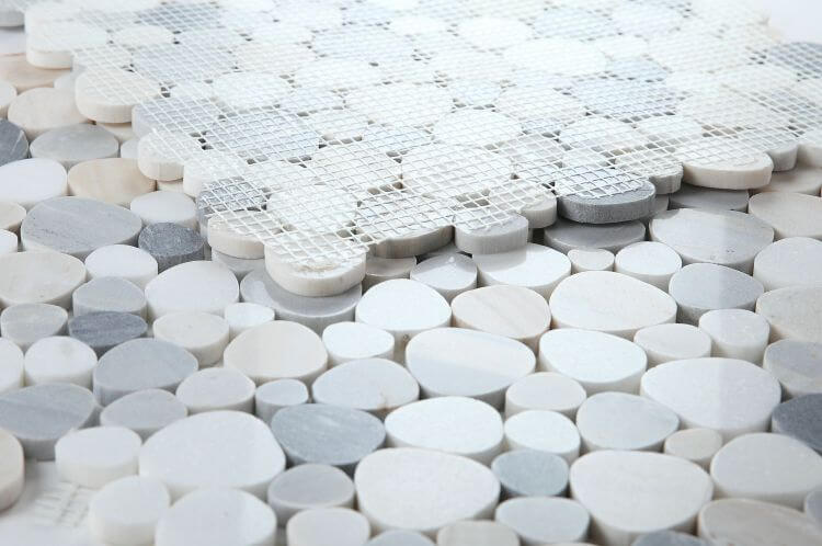 Close-up of Aphrodite Beach 12x12 mosaic tiles with heart-shaped pieces in Palissandro White, Blue, and White Thassos marble.