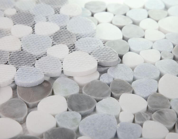 Close-up of Thassos White and Bardiglio Gray mosaic tiles in various round shapes, perfect for modern home decor.