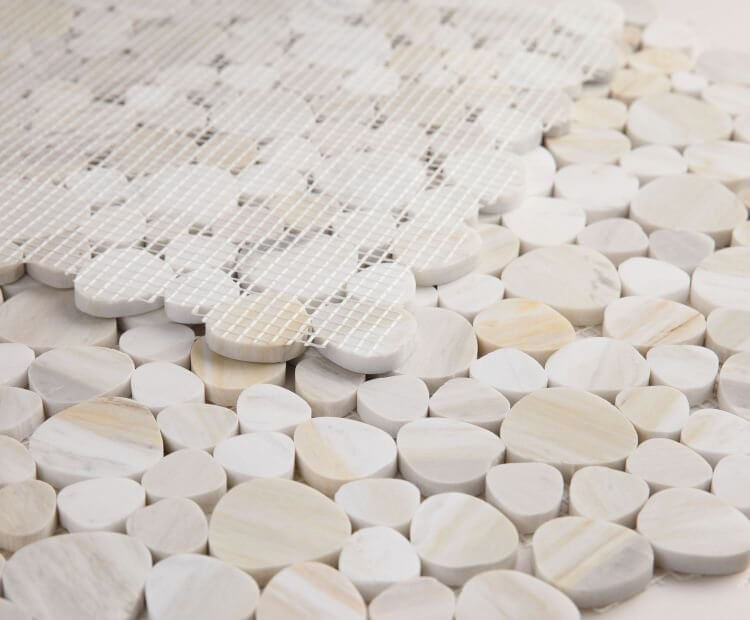 Close-up of Aphrodite Eura Wood Mosaics showcasing heart-shaped beige marble pieces arranged naturally.
